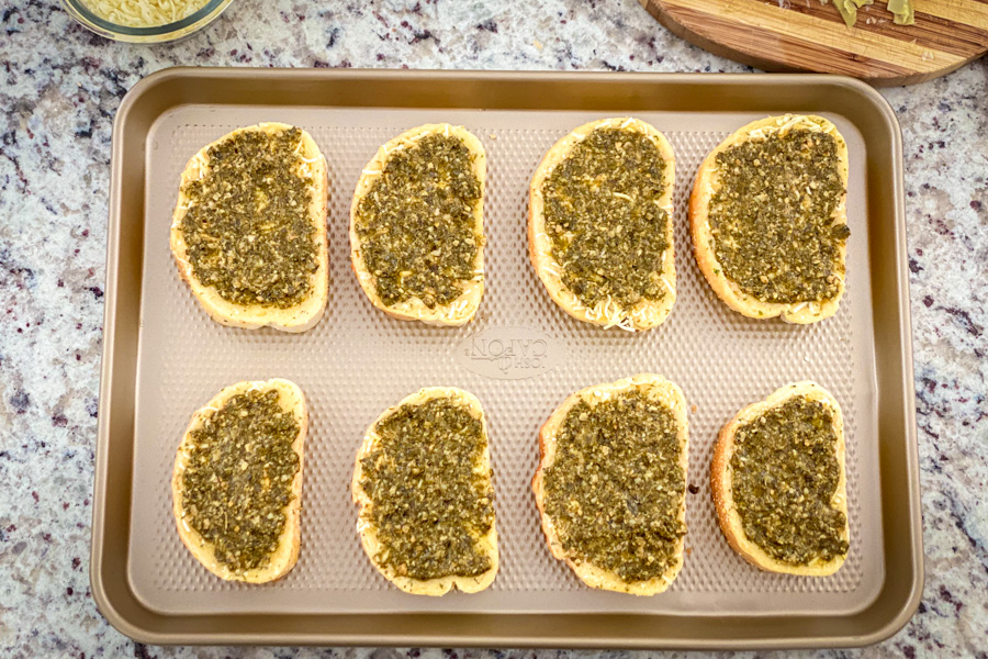 5 Cheese Texas Toast with pesto on it on a baking sheet