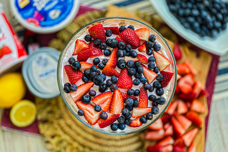 A top down view of our easy berry trifle surround by all the ingredients for the dish. 