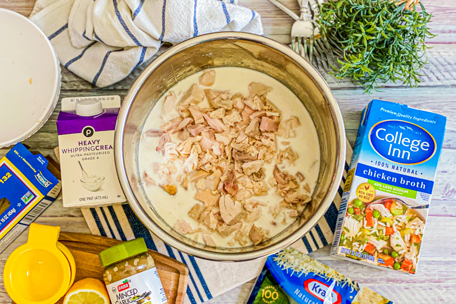 Cooked, shredded chicken add to the instant pot mixture of cream, broth, and pasta. 