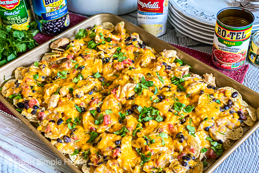 The Creamy Slow Cooker Chicken Nachos on a baking sheet after being cooked. It is ready to serve!