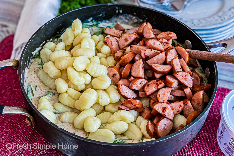 The cook sausage and gnocchi placed on top of the spinach and cream mixture before being mixed. 